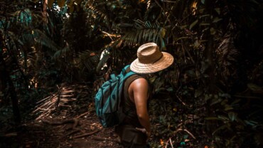 A traveler packing reusable essentials, showcasing a zero-waste mindset for sustainable travel.