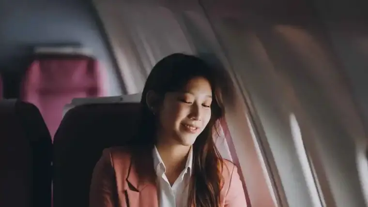 A calm traveler practicing relaxation techniques before a flight, symbolizing strategies for overcoming the fear of flying.