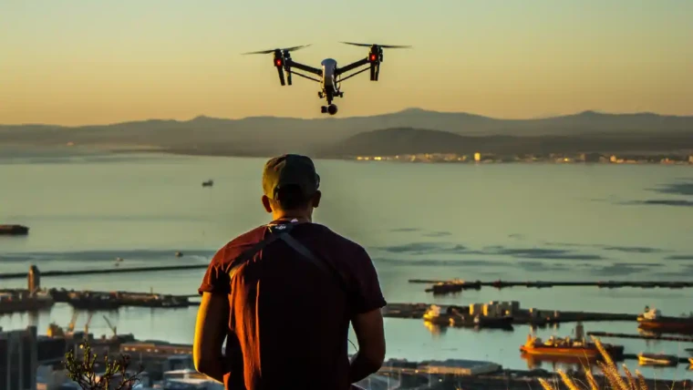 A traveler flying a drone over a scenic landscape, capturing stunning aerial footage.