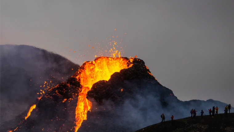 Reykjavik volcanic eruption with glowing lava and tourists observing from a safe distance.